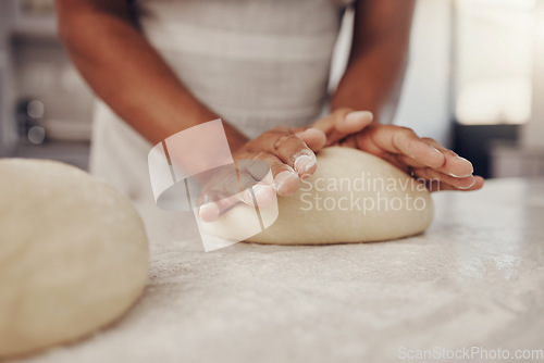 Image of Man hands and dough press in kitchen for baking preparation work and process at culinary counter. Restaurant chef and worker in professional kitchen preparing wheat bread, cake or pizza recipe.