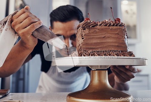 Image of Piping, chef and man baker baking a cake with chocolate in a kitchen or pastry cook preparing a sweet recipe. Food, dessert and cook preparing a sweet meal in Brazil and adds cream or icing