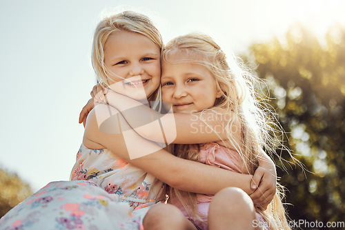Image of Hug, nature and portrait of girl siblings bonding, hugging and playing together in a park. Happy, smile and sisters embracing with care, love and friendship in a green garden on holiday in Canada.