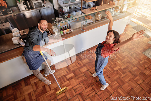 Image of Coffee shop, portrait and barista couple cleaning, having fun and bonding in their restaurant. Startup, small business and top view of young owners or entrepreneurs preparing their cafe for work.