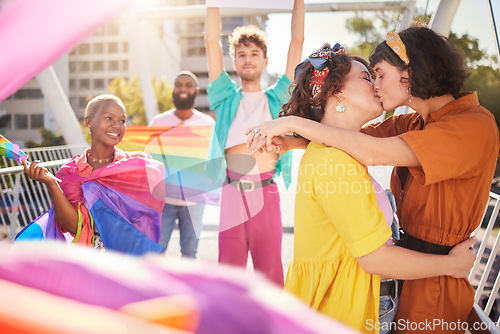 Image of Lgbt, kiss and couple of friends in city with rainbow flag for support, queer celebration and relationship. Diversity, lgbtq community and group of people enjoy freedom, happiness and pride identity