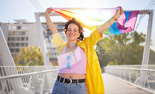 Image of Portrait, pride and lesbian woman with flag on city bridge, lgbtq community, identity with support and equality in love Rainbow, lifestyle and lgbt awareness, inclusion and celebrate with sexuality