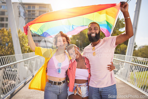 Image of Portrait, rainbow and flag with a lgbt friends outdoor together for diversity, gay pride or freedom. Support, equality and human rights with a man and woman friend group standing outside for politics