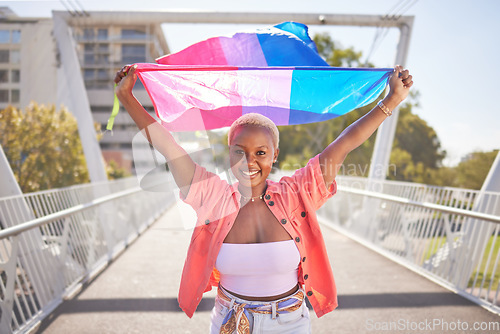 Image of Portrait, pride and black woman with flag on city bridge, lgbtq community and lesbian, identity and equality in love. Rainbow, outdoor and lgbt awareness, inclusion and celebration with sexuality