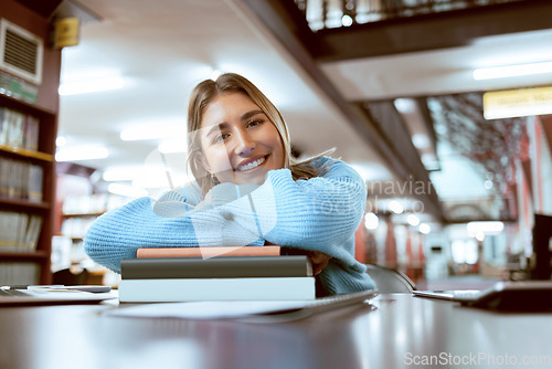 Image of Portrait, woman and student in library, studying and higher education for knowledge, growth or learning. University, female academic or lady with books, smile or relax with scholarship or information