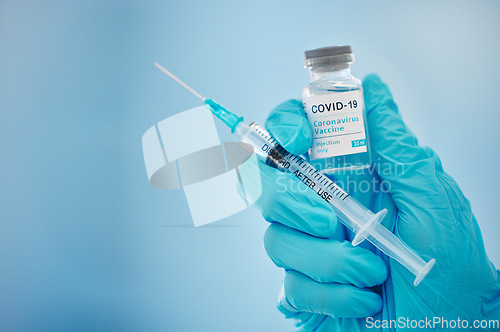 Image of Doctor, hands and covid vaccine for cure, healthcare or medical syringe medication to combat the virus. Hand of nurse holding corona virus sample with needle for vaccination from illness or disease