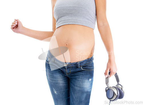 Image of Music, pregnant and woman stomach in studio for dance, fun and celebration on white background. Headphones, pregnancy and belly of pregnant woman listen to podcast for wellness, standing and isolated