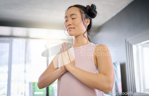 Image of Yoga, meditation and praying woman training her mind for peace, zen and calm start to the morning. Hope, freedom and Asian girl in the living room for a mindset exercise, spiritual and mindfulness