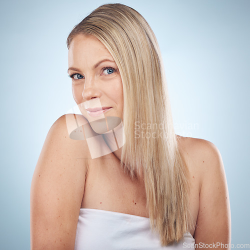 Image of Skincare, beauty and portrait of a woman with hair care isolated on a blue background in a studio. Spa, wellness and cosmetology model with facial makeup, cosmetics and dermatology on a backdrop