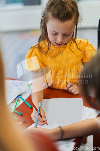 Image of Creative kids sitting in a preschool institution, draw and have fun while they get an education