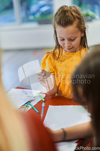 Image of Creative kids sitting in a preschool institution, draw and have fun while they get an education