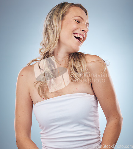 Image of Beauty, skincare and laugh with a model woman in studio on a gray background enjoying a joke or humor. Facial, cosmetics and funny with an attractive young female laughing for natural treatment