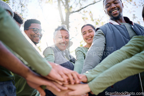 Image of Teamwork, motivation and huddle with senior friends hiking together in the forest or woods from below. Fitness, exercise or nature with a mature man and woman friend group putting hands in a circle