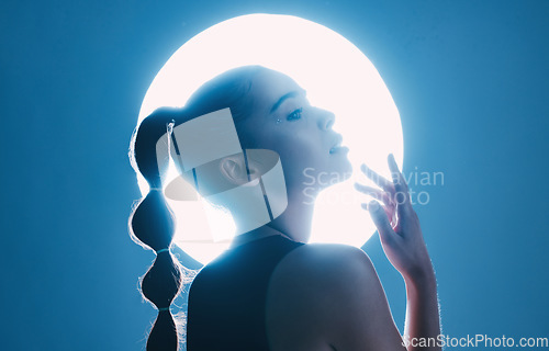 Image of Magical, beautiful and face of a girl with lighting isolated on a dark background in a studio. Idea, creative and woman thinking of futuristic glow from light, art and cosmetics on a backdrop