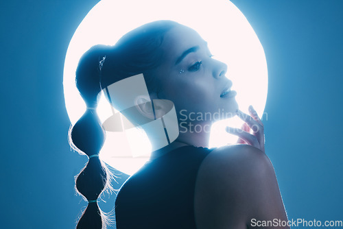 Image of Thinking, cinematic and face of a girl with a spotlight isolated on a dark background in a studio. Idea, creative and woman with a futuristic glow from light, art and cosmetics on a backdrop