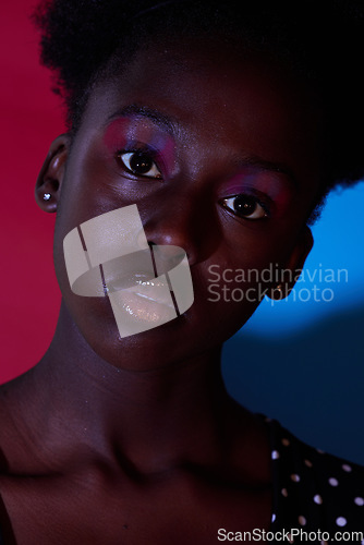 Image of Trendy, aesthetic and portrait of black woman in dark color lighting isolated on a studio background. Neon, art and face of an African girl with creativity, makeup and stylish on a creative backdrop