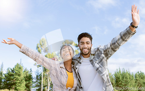 Image of Portrait, couple of friends and freedom of hiking in nature, forest and park. Diversity, man and woman celebrate journey, achievement and adventure on blue sky with motivation, smile and happiness