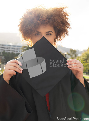 Image of University student girl, portrait and graduation cap to hide face with success, achievement and goal. Black woman, graduate celebration and vision in education, learning and future career in sunshine