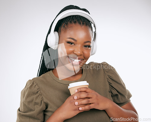 Image of Headphones, black woman smile and music portrait with coffee of a happy young person in a studio. White background, isolated and happiness of a excited female hearing audio and singing to song alone