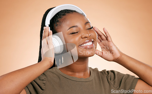 Image of Headphones, music and african woman isolated on studio background for mental health, energy and wellness podcast. Happy, calm black people listening to audio with smile on face for stress free sound