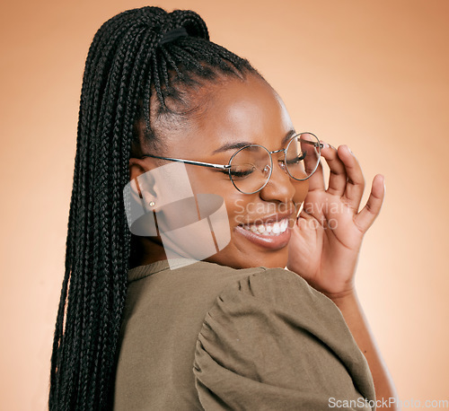 Image of Happy black woman, face and holding glasses with smile, vision and excited, prescription lens isolated on studio background. Eyewear, eye care and healthcare for eyes, fashion frame and optometry