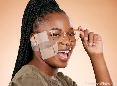 Image of Black woman, face and holding glasses for fashion, style or smart casual against a studio background. Portrait of happy African American female model smile for eyewear, spectacles and sight or vision