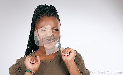 Image of Silly, happy and black woman face with sassy emoji attitude facial expression in studio. White background, isolated and young model with fashion fashion with comic, crazy and goofy gesture alone