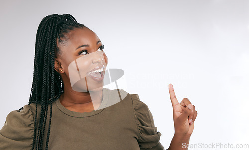 Image of Mockup, thinking and black woman pointing at studio background, advertising space and wall. Happy female model, ideas and product placement of marketing, promotion announcement and commercial review