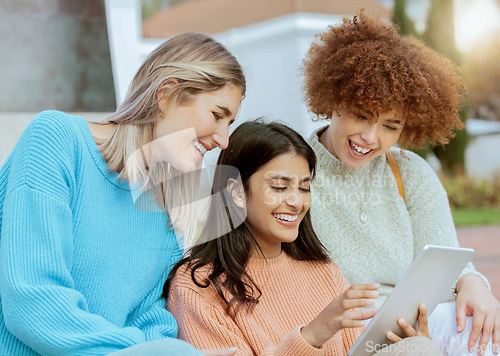 Image of Student, friends and tablet laughing for meme, social media or streaming online entertainment at campus. Happy women sharing laugh for funny joke, chat or post on touchscreen together at university