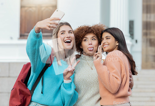 Image of Women students, selfie and peace with hug at college campus for goals, comic and social network. Gen z woman, group and smartphone with funny face, happiness and studying at university for success