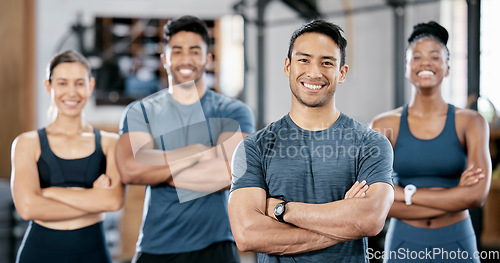 Image of Fitness, portrait and man personal trainer with clients standing with crossed arms in the gym. Sports, collaboration and happy people after exercise, workout or training class in sport studio.