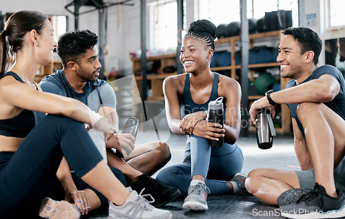 Image of Fitness, conversation and friends at the gym for training, exercise motivation and relax after cardio. Laughing, happy and people with a group discussion about a workout, health class and performance