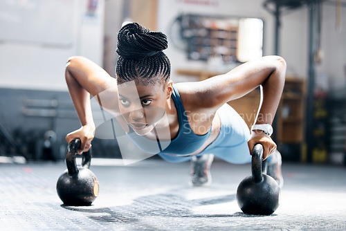Image of Fitness, push up or black woman with kettlebell for training, body workout or exercise at health club. Motivation, mindset or African girl sports athlete exercising with focus or resilience at gym