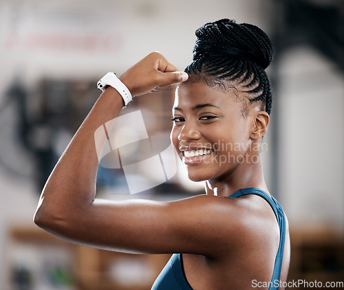 Image of Portrait, fitness or black woman flexing muscle or body goals in training, workout or exercise at gym. Strong person, results or healthy African girl athlete with powerful biceps, motivation or focus