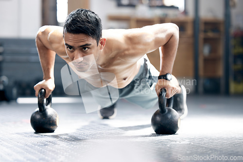 Image of Fitness, push up or man with kettlebell for training, body workout or exercise at health club studio. Motivation, mindset or healthy Indian sports athlete exercising with focus or resilience at gym