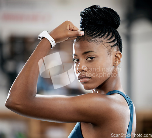 Image of Portrait, fitness or black woman with strong biceps muscle or body goals in training, workout or exercise at gym. Face, results or healthy African girl sports athlete with power, motivation or focus