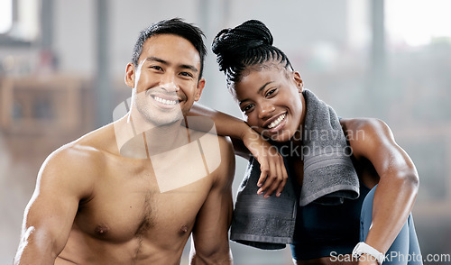 Image of Portrait, fitness and diversity with a sports couple sitting in the gym together after a workout for health. Exercise, happy and strong with a man and woman athlete sitting in a training facility