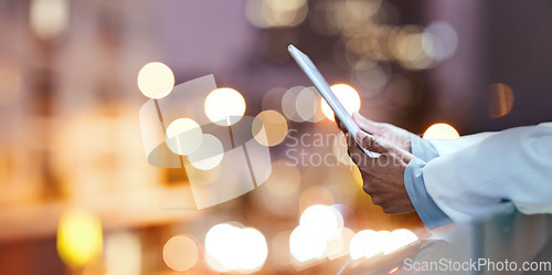 Image of Bokeh, tablet hands and doctor on hospital rooftop working on telehealth, research or online consultation in city. Healthcare, woman and physician with technology for wellness app in clinic at night