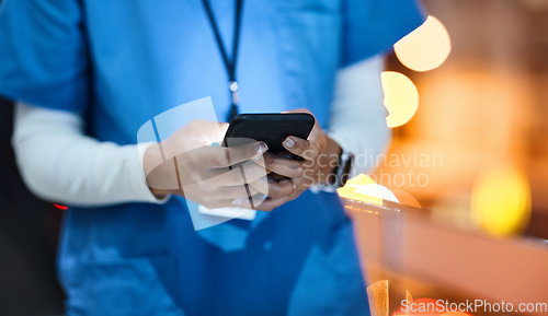 Image of Doctor, phone and healthcare worker hands of a hospital employee at night on social media. Online consulting, mobile communication and wellness consultant woman at a clinic writing a text on web app