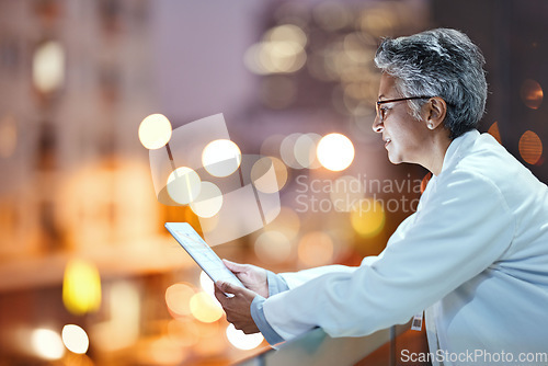 Image of Tablet, senior woman and doctor on rooftop in hospital working on telehealth, research or online consultation in city. Bokeh, healthcare and female physician with technology for wellness app at night