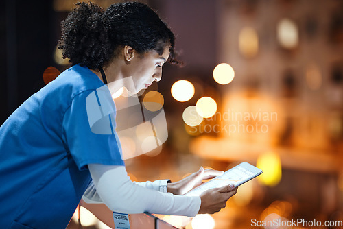 Image of Tablet, woman and nurse on hospital rooftop working on telehealth, research or online consultation in city. Bokeh, healthcare physician and female with technology for wellness app in clinic at night.