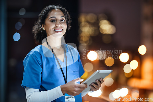 Image of Tablet, city and portrait of a woman doctor doing research at night on rooftop of hospital building. Medical, lights and female healthcare worker working late on mobile device on balcony of clinic.