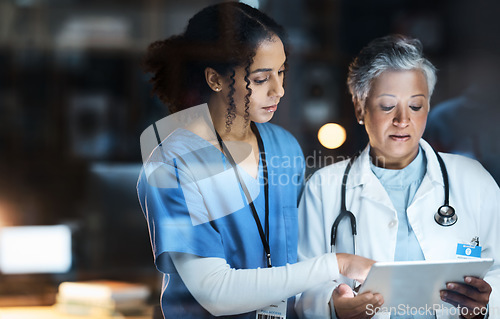 Image of Women, doctors and tablet for night medical research, surgery planning and teamwork in hospital. Nurse, healthcare and worker collaboration on technology in late shift for wellness thinking and ideas