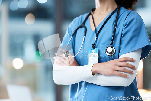 Image of Woman arms crossed, doctor and night in hospital, workplace and medical career vision on nightshift. Confident healthcare expert, dark clinic and focus goal with hands, safety and help for emergency