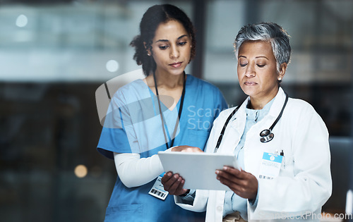 Image of Doctors, women and digital tablet for night teamwork, medical research or surgery planning in wellness hospital. Thinking, healthcare and worker nurse in collaboration on technology for late schedule