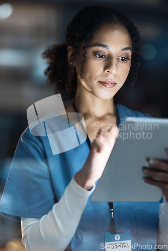 Image of Medical tablet, nurse and black woman in hospital working late on telehealth, research or online consultation. Tech, healthcare or female physician with technology for wellness app in clinic at night