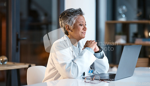 Image of Doctor, laptop and senior woman in hospital working late or overtime on email, telehealth or research. Elderly, health and female medical physician reading healthcare information at night on computer