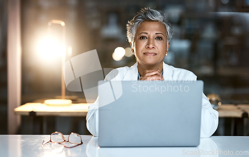 Image of Doctor, laptop and portrait of senior woman in hospital working late or overtime on email, telehealth or research. Elderly, healthcare and confident female medical physician by computer at night.