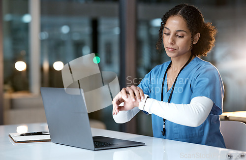 Image of Laptop, watch and night with a black woman nurse working overtime on research in a hospital for healthcare. Computer, medical and time with a female medicine professional at work late in the evening