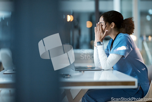 Image of Nurse, burnout stress and black woman in hospital feeling pain, tired or sick on night shift. Healthcare, wellness and female medical physician with depression or anxiety while working late on laptop